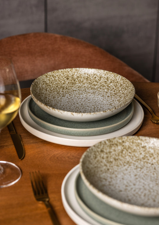 Gedekte tafelsetting met minimalistisch, mat servies van Mimo Homeware in wit, groen en beige.